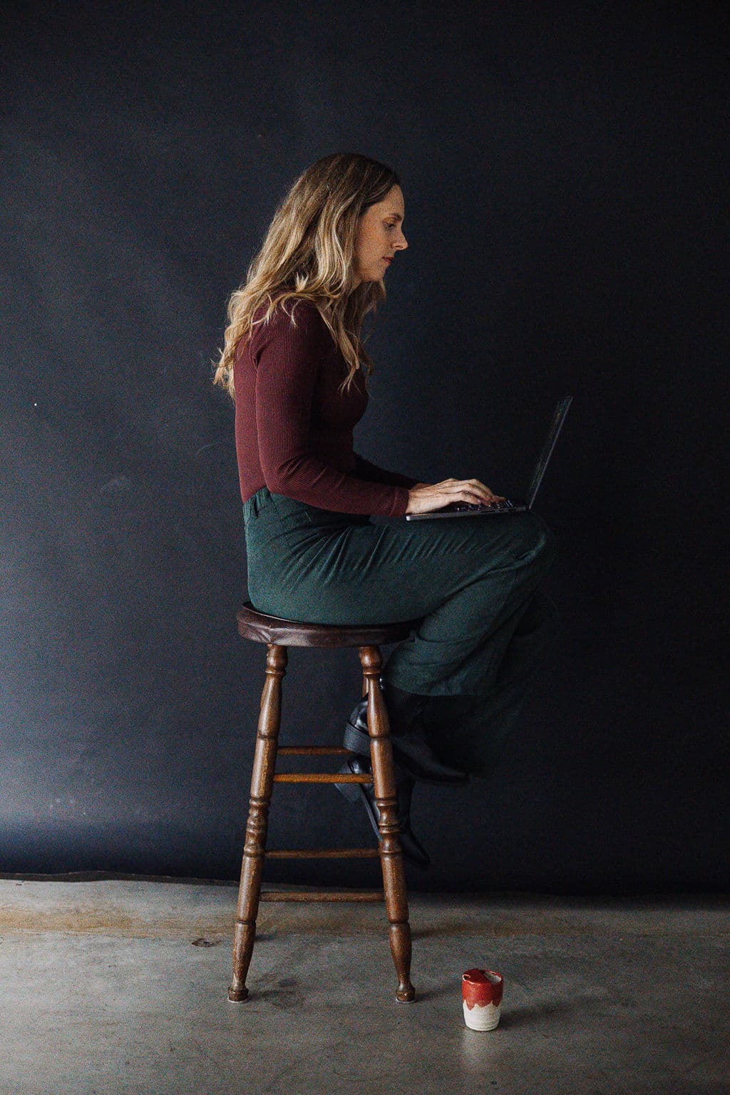 Brooke working at her laptop in the studio