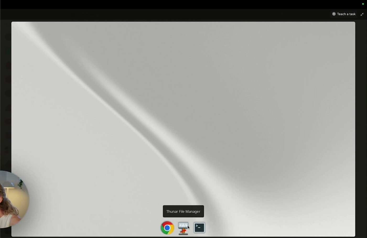 Grok Bot's own cloud computer, showing a desktop with Chrome, a file manager and a terminal in the dock, and a Teach a task button in the top corner